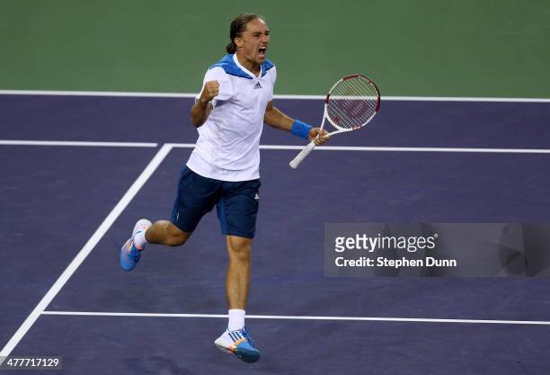 Alexandr Dolgopolov of The Ukraine celebrates after winning match point against Rafael Nadal of Spain during the BNP Paribas Open at Indian Wells...
