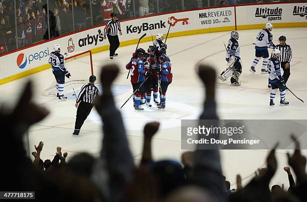 The fans join the celebration after Matt Duchene of the Colorado Avalanche scored the game winning goal in overtime against goalie Al Montoya of the...