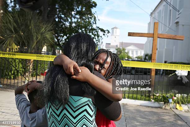 Kearston Farr comforts her daughter, Taliyah Farr as they stand in front of the Emanuel African Methodist Episcopal Church after a mass shooting at...
