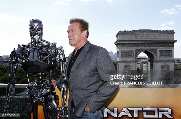 Actor Arnold Schwarzenegger poses during a photo call for the film "Terminator Genisys" on June 19, 2015 on a terrace overlooking the Arc de Triomphe...