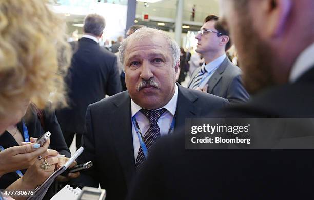 Eduard Khudainatov, former chief executive officer of Rosneft OAO, speaks with attendees between sessions at the St. Petersburg International...