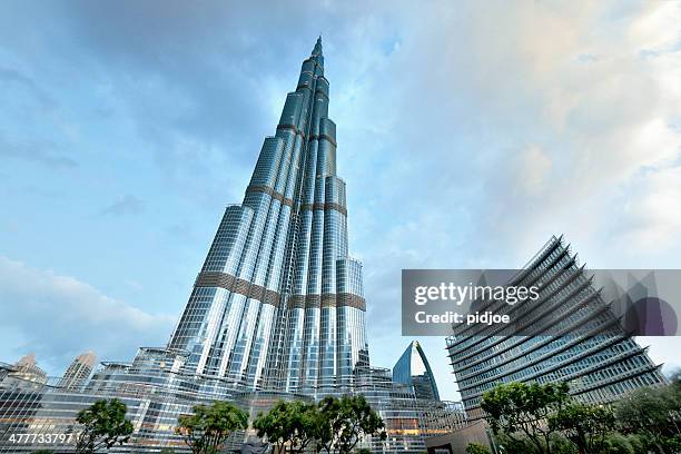 dubai's highrise burj khalifa just after sunrise - burj khalifa stock pictures, royalty-free photos & images