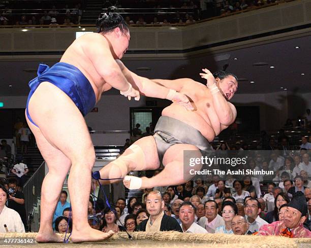 Mongolian sekiwake kakuryu throws Toyonoshima out of the ring to win during day four of the Grand Sumo Autumn Tournament at Ryogoku Kokugikan on...