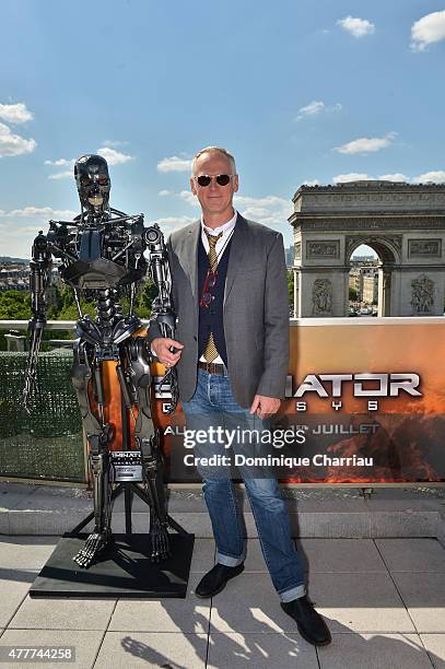 Director Alan Taylor poses with Endoskeleton during the France Photocall of 'Terminator Genisys' at the Publicis Champs Elysees on June 19, 2015 in...