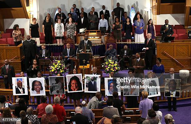 Photographs of the nine victims killed at the Emanuel African Methodist Episcopal Church in Charleston, South Carolina are held up by congregants...