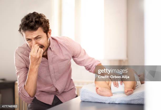 father changing diaper - changing nappy stock pictures, royalty-free photos & images