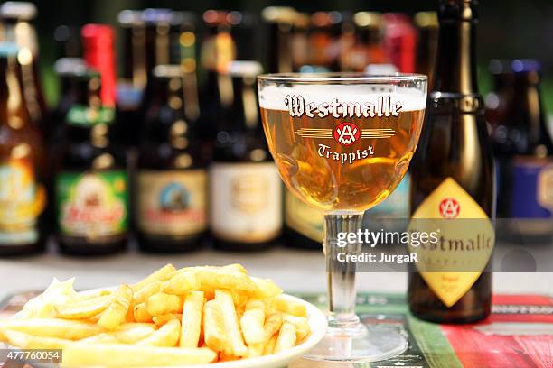 belgian beer westmalle trappist tripel and belgian fries - belgium beer stock pictures, royalty-free photos & images