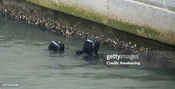Police divers inspect the canal of the Canonica ahead of the arrival to Saint Mark's Cathedral of First Lady Michelle Obama and her daughters on June...