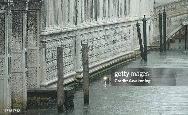 Police diver inspect the canal of the Canonica ahead of the arrival to Saint Mark's Cathedral of First Lady Michelle Obama and her daughters on June...