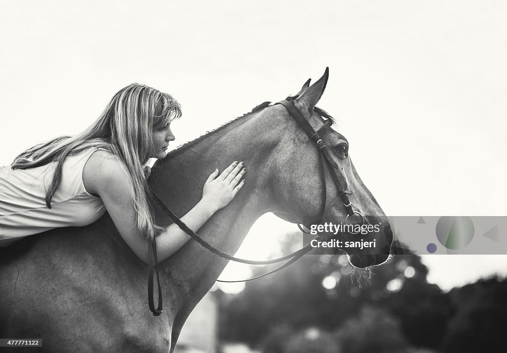 Young woman riding a horse in nature