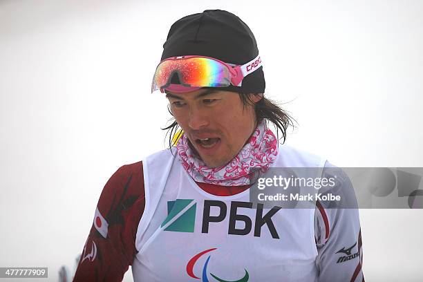 Keiichi Sato of Japan reacts after crossing the finish line in the Men's Biathlon 12.5km - Standing during day four of Sochi 2014 Paralympic Winter...