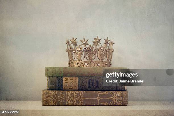 crown on vintage books - gold crown stock pictures, royalty-free photos & images