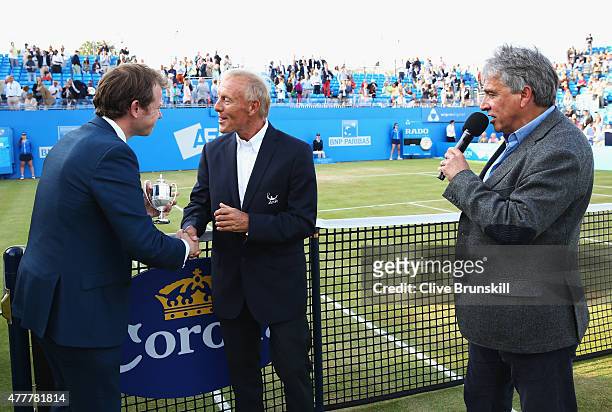 Retiring umpire Gerry Armstrong is presented with a miniature Aegon Championship trophy by Tournament Director Stephen Farrow watched by John...