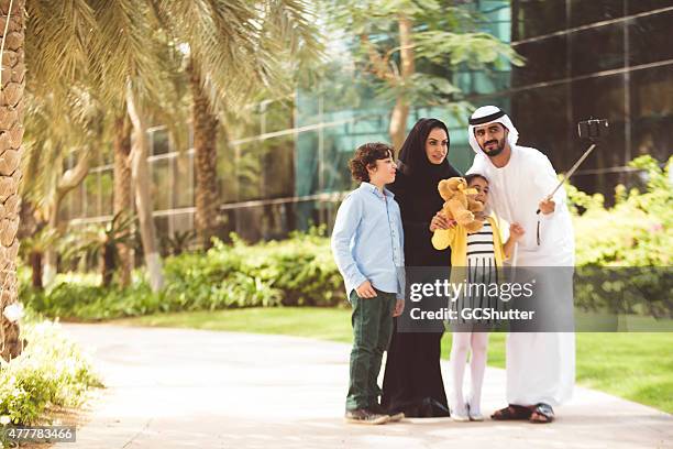 young arab family in a park taking selfie - men selfie wide stock pictures, royalty-free photos & images