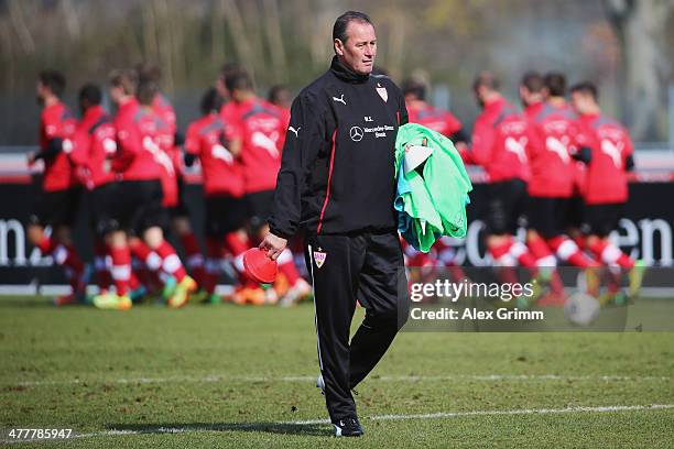 Head coach Huub Stevens walks on the pitch during a VfB Stuttgart training session at the club's training ground on March 11, 2014 in Stuttgart,...