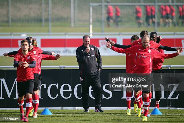 Head coach Huub Stevens watches his players exercise during a VfB Stuttgart training session at the club's training ground on March 11, 2014 in...