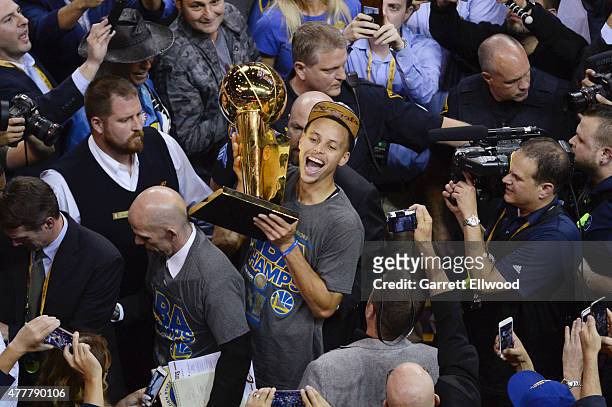 Stephen Curry of the Golden State Warriors celebrates winning the Larry O'Brein Trophy after Game Six of the 2015 NBA Finals against the Cleveland...