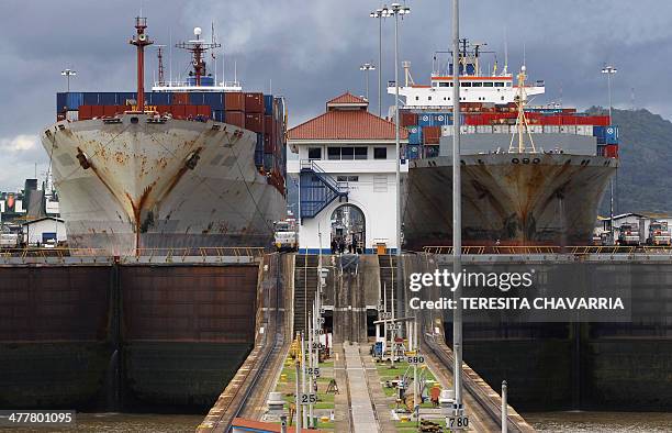 Two cargos full of containers sail in the MIraflores locks in the Panama Canal, 25kms noreast of Panama City, 16 October, 2006. A referendum will be...