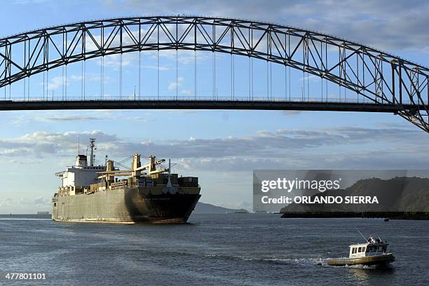 Ship sails under the Las Americas bridge in the Pacific Ocean's entry of the Panama Canal 19 October 2006. Voters will approve a 5.25 billion dollar...