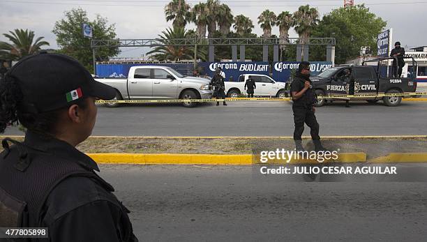 Members of the mexican police guard the place where gunmen stormed a beer hall in northern Garcia, Nuevo Leon state Mexico, killing 10 people in a...