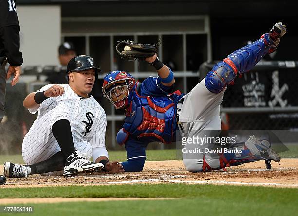 Robinson Chirinos of the Texas Rangers tags out Avisail Garcia of the Chicago White Sox at home plate during the fourth inning on June 19, 2015 at U....