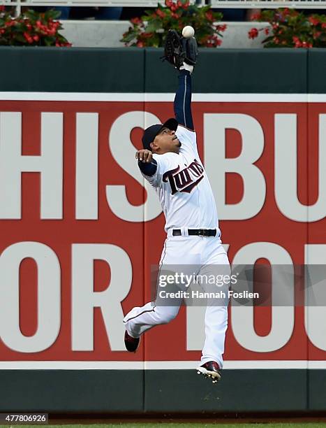 Eduardo Escobar of the Minnesota Twins makes a catch of the ball hit by Miguel Montero of the Chicago Cubs in left field during the fourth inning of...