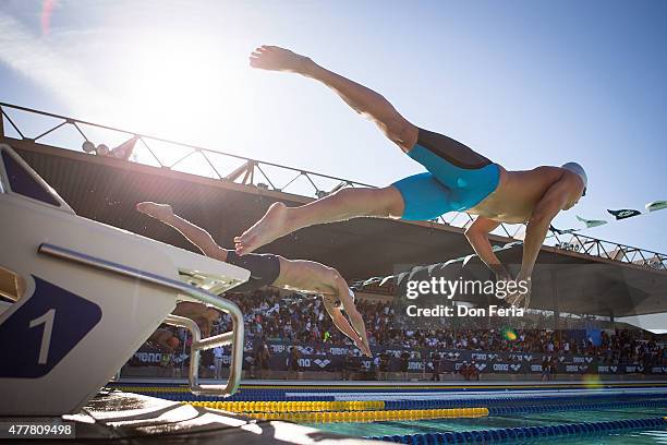 Athletes leave the diving board on day two of the 2015 Arena Pro Swim Series at the George F. Haines International Swim Center on June 19, 2015 in...