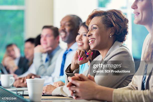 african american businesswoman attending seminar or job training business conference - training course stock pictures, royalty-free photos & images