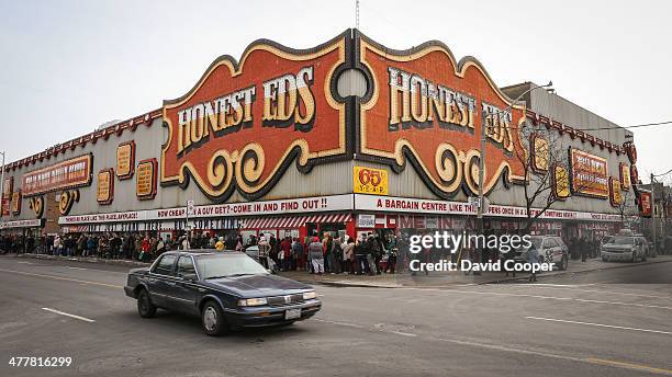 Massive crowd of shoppers nearly encircled the block around Honest Ed's waiting patiently for their turn to go inside and purchase show cards with...