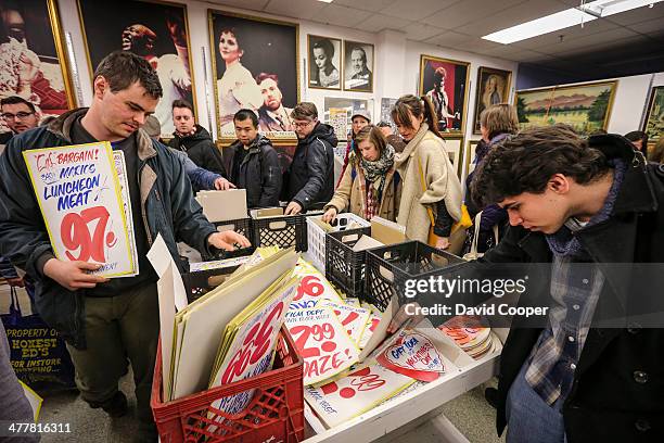 Massive crowd of shoppers nearly encircled the block around Honest Ed's waiting patiently for their turn to go inside and purchase show cards with...