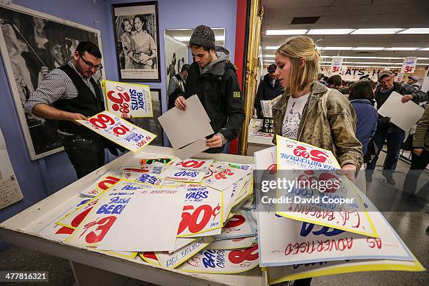 Massive crowd of shoppers nearly encircled the block around Honest Ed's waiting patiently for their turn to go inside and purchase show cards with...