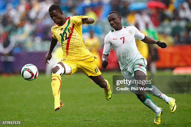 Souleymane Coulibaly of Mali kicks ahead past Ibrahima Wadji of Senegal during the FIFA U-20 World Cup Third Place Play-off match between Senegal and...