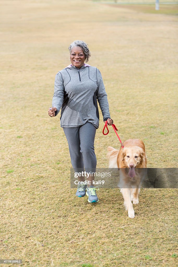 African American woman walking dog