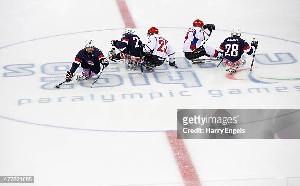 Joshua Sweeney of USA comes away with the puck at the start of the Ice Sledge Hockey Preliminary Round Group B match between USA and Russia at the...