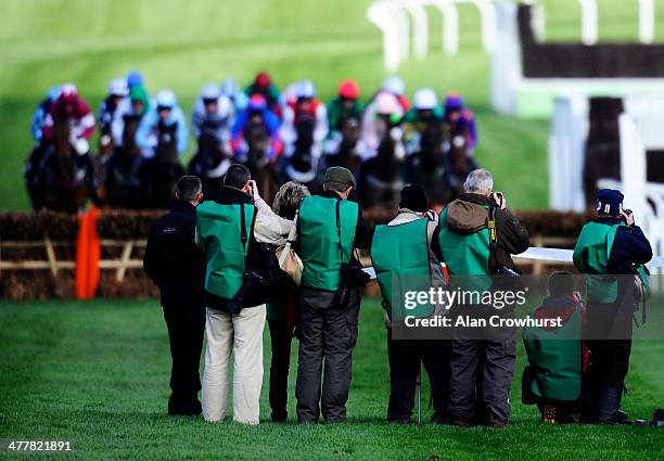 Photographers Photographing the action at Cheltenham racecourse on March 11, 2014 in Cheltenham, England.