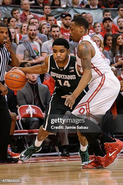 Gary Harris of the Michigan State Spartans controls the ball as Lenzelle Smith, Jr. #32 of the Ohio State Buckeyes defends on March 9, 2014 at Value...