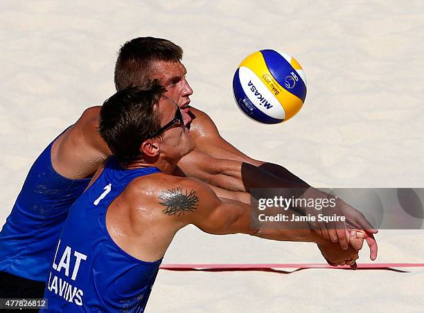 Martins Plavins and Haralds Regza of Lithuania return a serve on their way toward defeating Neilton Santos and Iaroslav Rudykh of Azerbaijan in the...