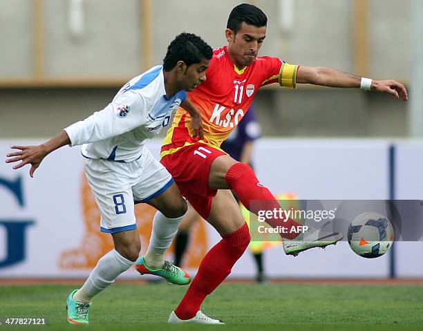 Iran's Foolad midfielder, Bakhtiar Rahmani challenges Hussain al-Moqahwi of Saudi Arabia's Al-Fateh during their AFC Champions League Group B...