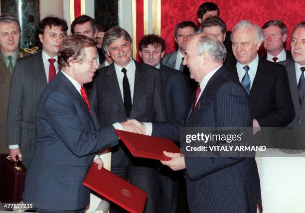 Former dissident playwright and Czechoslovakian President Vaclav Havel and Soviet President Mikhail Gorbachev shake hands as they exchange documents...