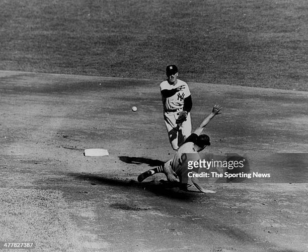 Tony Kubek of the New York Yankees turns a double play over Bill Mazeroski of the Pittsburgh Pirates in Game Five of the 1960 World Series October...