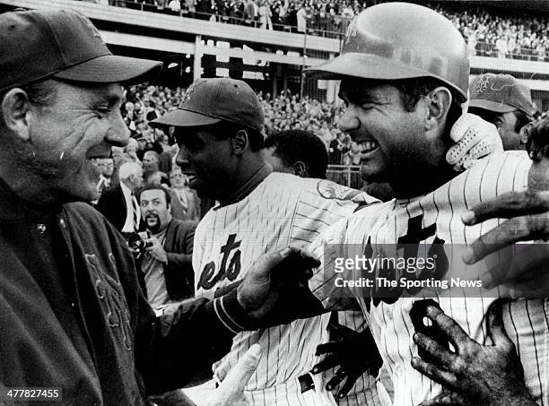 New York Mets manager Gil Hodges and Donn Clendenon rush to congratulate J.C. Martin on his game-winning bunt after the Mets' 2-1 victory over the...