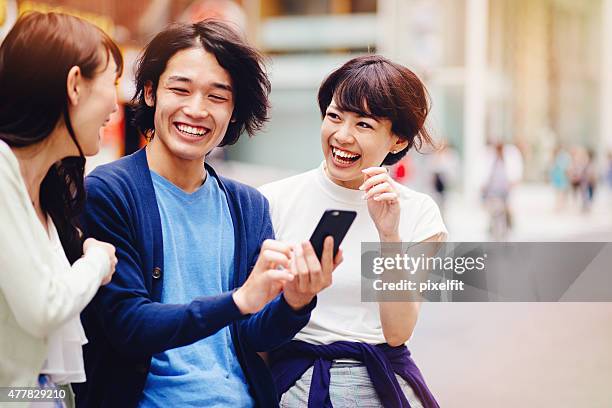 group of young japanese people with smart phone - guy girl street laugh stock pictures, royalty-free photos & images