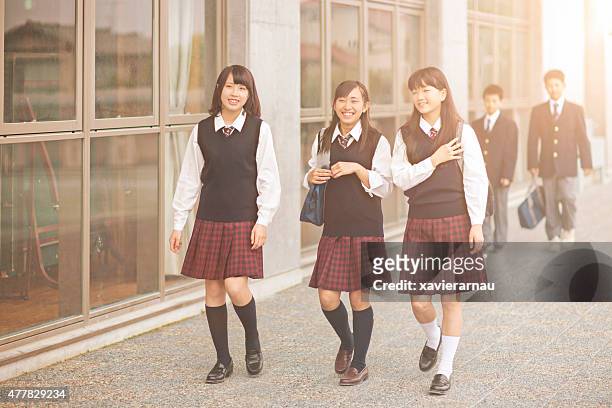japanese students walking outside the school yard - japan 12 years girl stock pictures, royalty-free photos & images