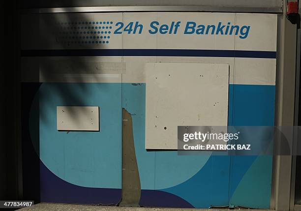 The ATM machine of a bank appears sealed off in Nicosia on March 11, 2014. Cyprus was rescued from the brink of bankruptcy in March 2013 by an EU...