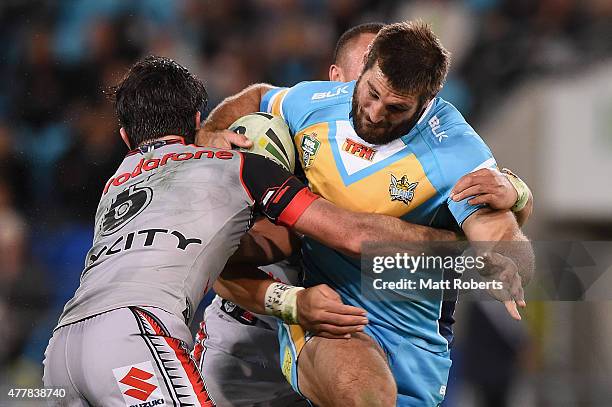 Dave Taylor of the Titans is tackled during the round 15 NRL match between the Gold Coast Titans and the New Zealand Warriors at Cbus Super Stadium...