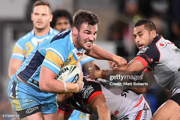 Luke Douglas of the Titans takes on the defence during the round 15 NRL match between the Gold Coast Titans and the New Zealand Warriors at Cbus...