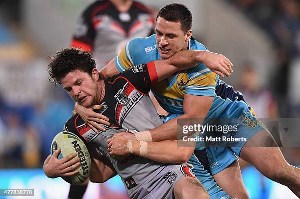 Chad Townsend of the Warriors is tackled during the round 15 NRL match between the Gold Coast Titans and the New Zealand Warriors at Cbus Super...