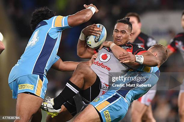 Solomone Kata of the Warriors is tackled during the round 15 NRL match between the Gold Coast Titans and the New Zealand Warriors at Cbus Super...