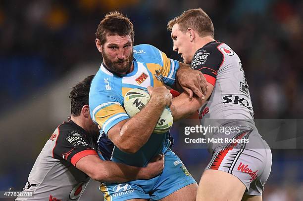 Dave Taylor of the Titans is tackled during the round 15 NRL match between the Gold Coast Titans and the New Zealand Warriors at Cbus Super Stadium...