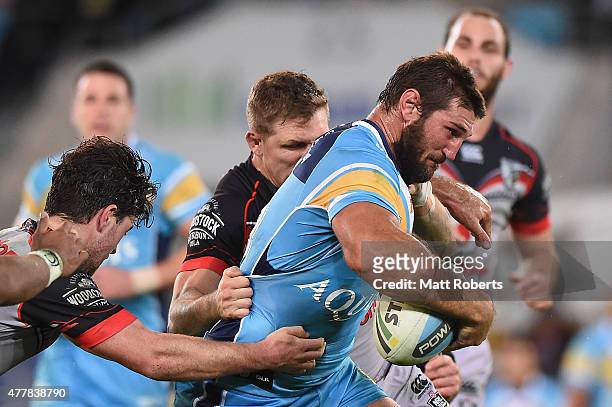Dave Taylor of the Titans takes on the defence during the round 15 NRL match between the Gold Coast Titans and the New Zealand Warriors at Cbus Super...